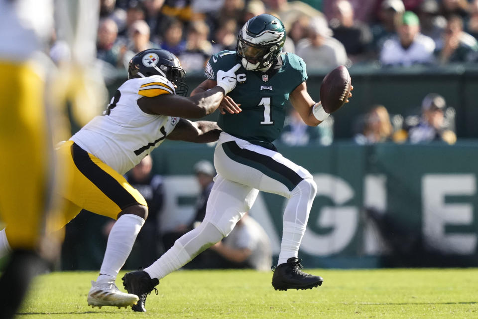 Philadelphia Eagles quarterback Jalen Hurts (1) avoids a tackle from Pittsburgh Steelers Khalil Davis during the first half of an NFL football game between the Pittsburgh Steelers and Philadelphia Eagles, Sunday, Oct. 30, 2022, in Philadelphia. (AP Photo/Matt Slocum)