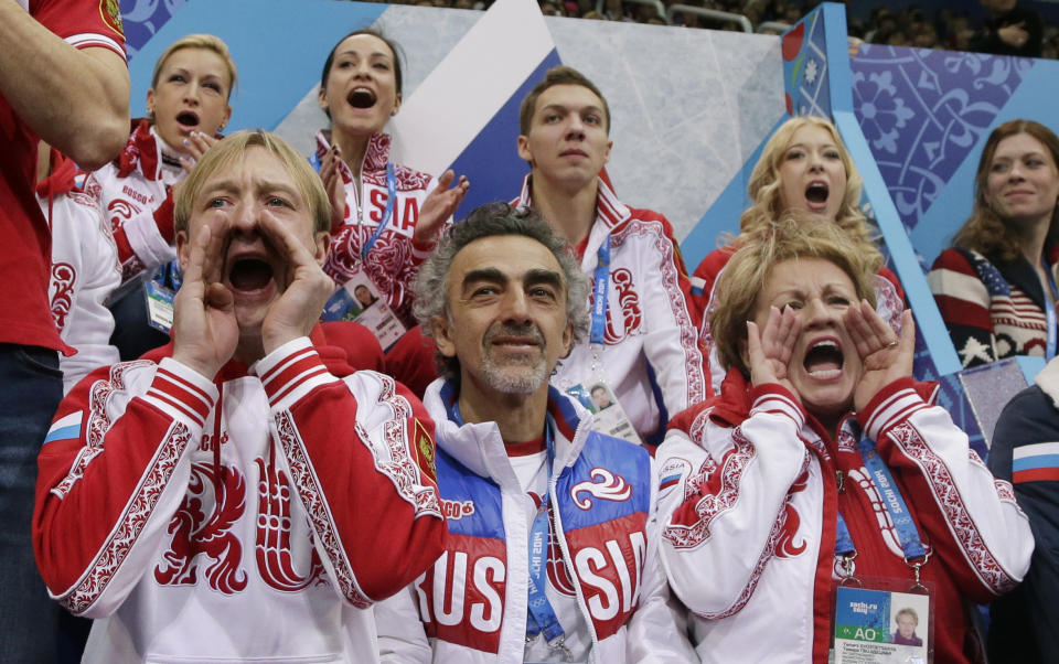 Evgeni Plushenko of Russia, front left, and other team members cheers for Julia Lipnitskaia of Russia as she competes in the women's team free skate figure skating competition at the Iceberg Skating Palace during the 2014 Winter Olympics, Sunday, Feb. 9, 2014, in Sochi, Russia. (AP Photo/Darron Cummings, Pool)