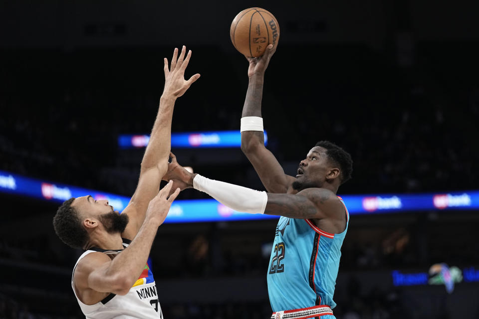 Phoenix Suns center Deandre Ayton (22) shoots against Minnesota Timberwolves center Rudy Gobert (27) during the first half of an NBA basketball game, Friday, Jan. 13, 2023, in Minneapolis. (AP Photo/Abbie Parr)