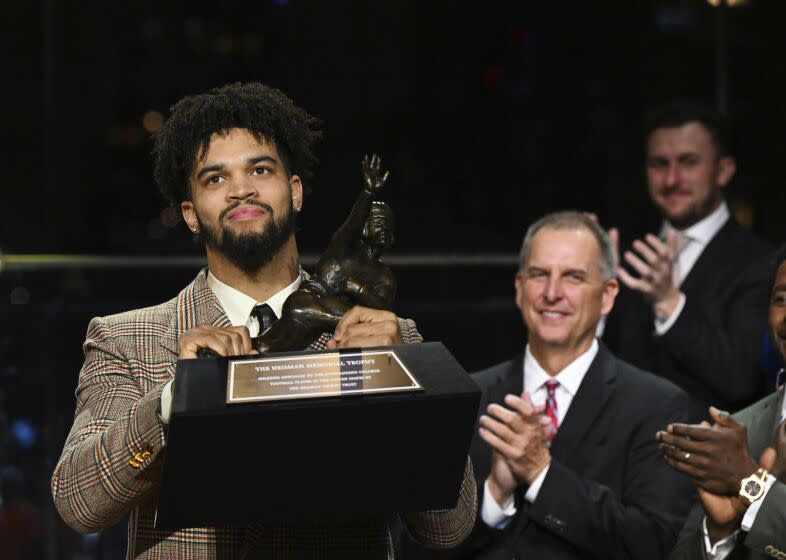 Southern California quarterback Caleb Williams holds the Heisman Trophy after winning the award.