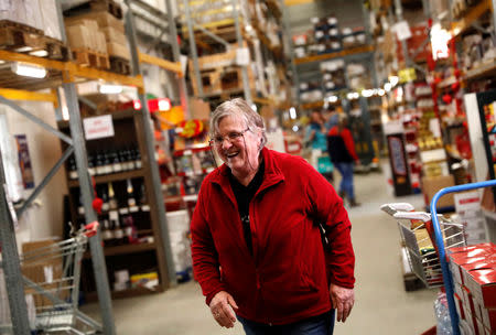 A 65-year-old pensioner, Zsuzsanna Czeizel smiles as she works in a warehouse in Budapest, Hungary February 6, 2019. Picture taken in February 6, 2019. REUTERS/Bernadett Szabo