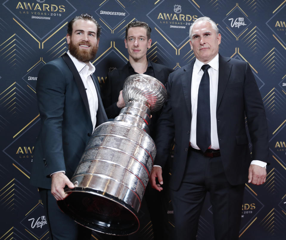 From left, Ryan O'Reilly, Jordan Binnington and Craig Berube of the St. Louis Blues pose with the Stanley Cup on the red carpet before the NHL Awards, Wednesday, June 19, 2019, in Las Vegas. (AP Photo/John Locher)