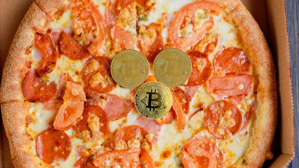 Kyiv, Ukraine  May 05, 2020. Golden bitcoin coins. Bitcoin Pizza Day 22 May. crypto community holiday. 2 pizzas for a price of 10000 Bitcoins. Pizza Index