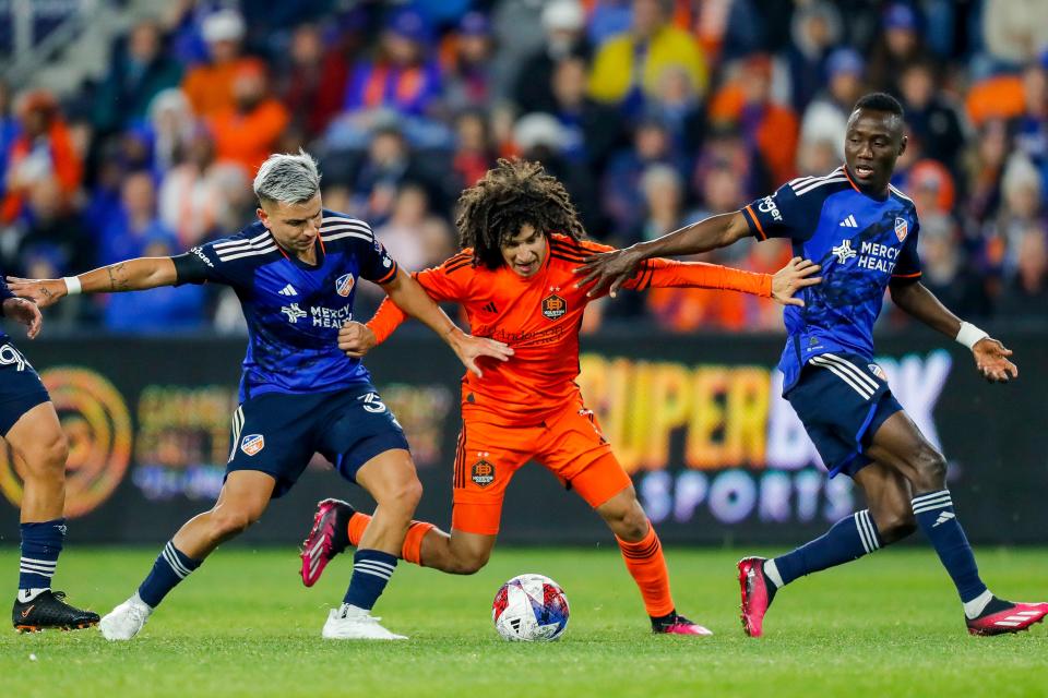 Houston Dynamo forward Ivan Franco, middle, battles for control of the ball against FC Cincinnati's Alvaro Barreal and Obinna Nwobodo during the second half of their match on Feb. 25.