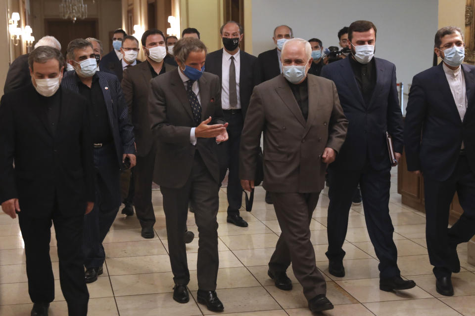 Director General of International Atomic Energy Agency, IAEA, Rafael Mariano Grossi, center left, speaks with Iran's Foreign Minister Mohammad Javad Zarif, center left, before a meeting in Tehran, Iran, Tuesday, Aug. 25, 2020. Grossi arrived in Iran on Monday to press for access to sites where authorities are thought to have stored or used undeclared nuclear material. (AP Photo/Vahid Salemi)