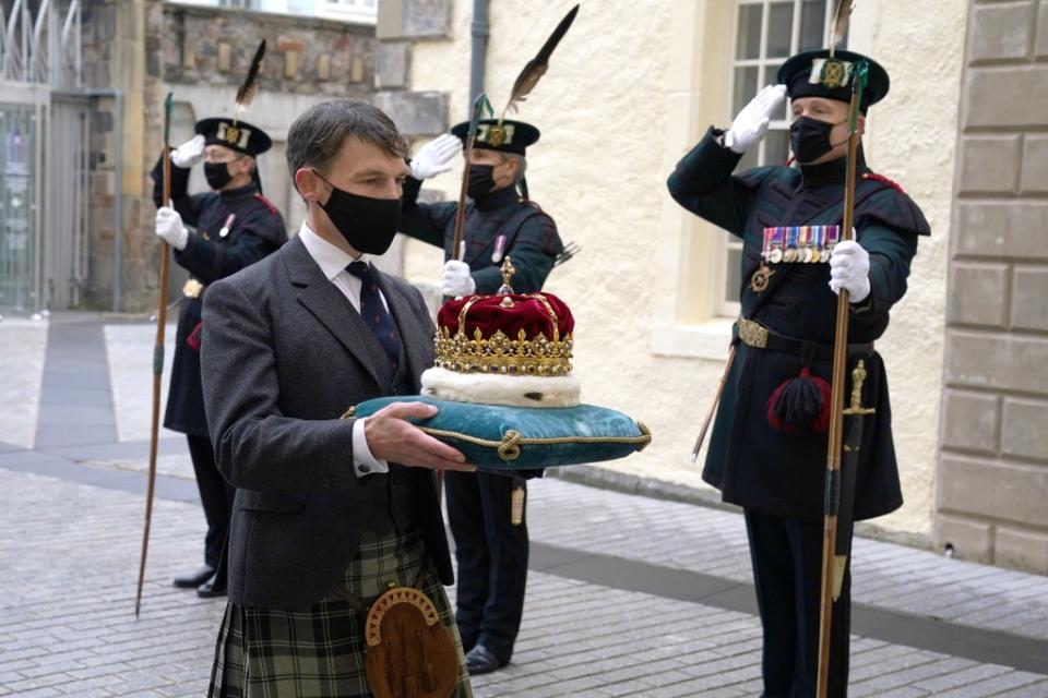 The Duke of Hamilton carries the Crown of Scotland into the Scottish Parliament (Andrew Milligan/{PA) (PA Wire)