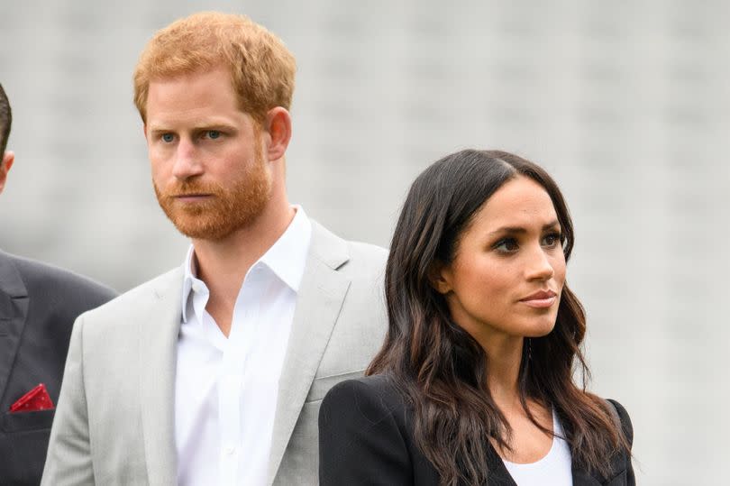 Meghan walked ahead of her husband who reportedly had his shoulders 'slumped' in new images