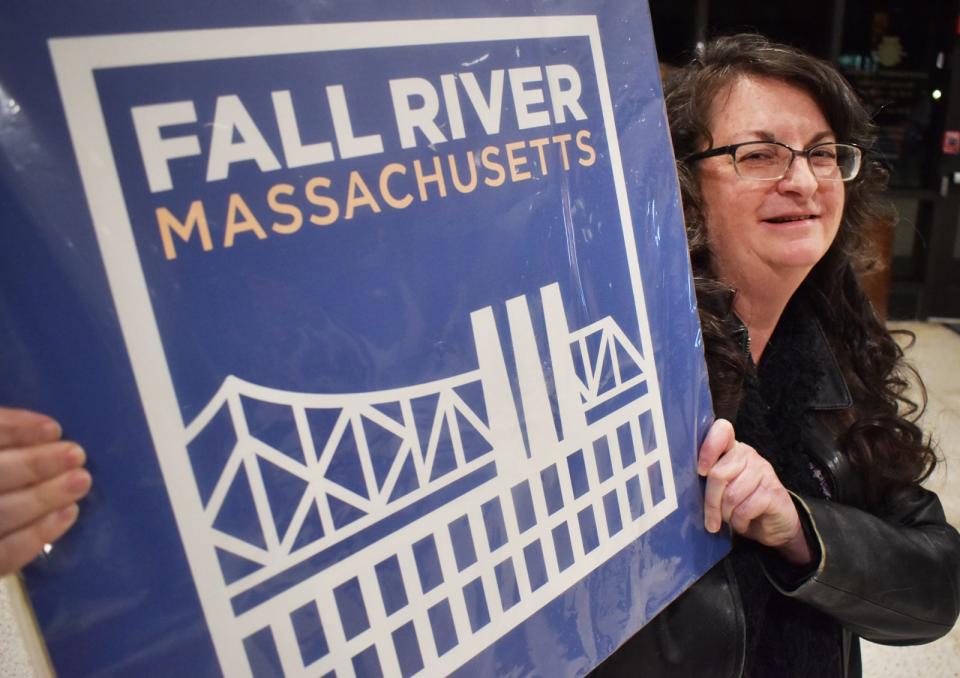 Tiverton resident Nadine Messier, winner of Fall River's Logo Design Contest, poses with her winning entry at a ceremony Tuesday, Jan. 31, at Government Center.