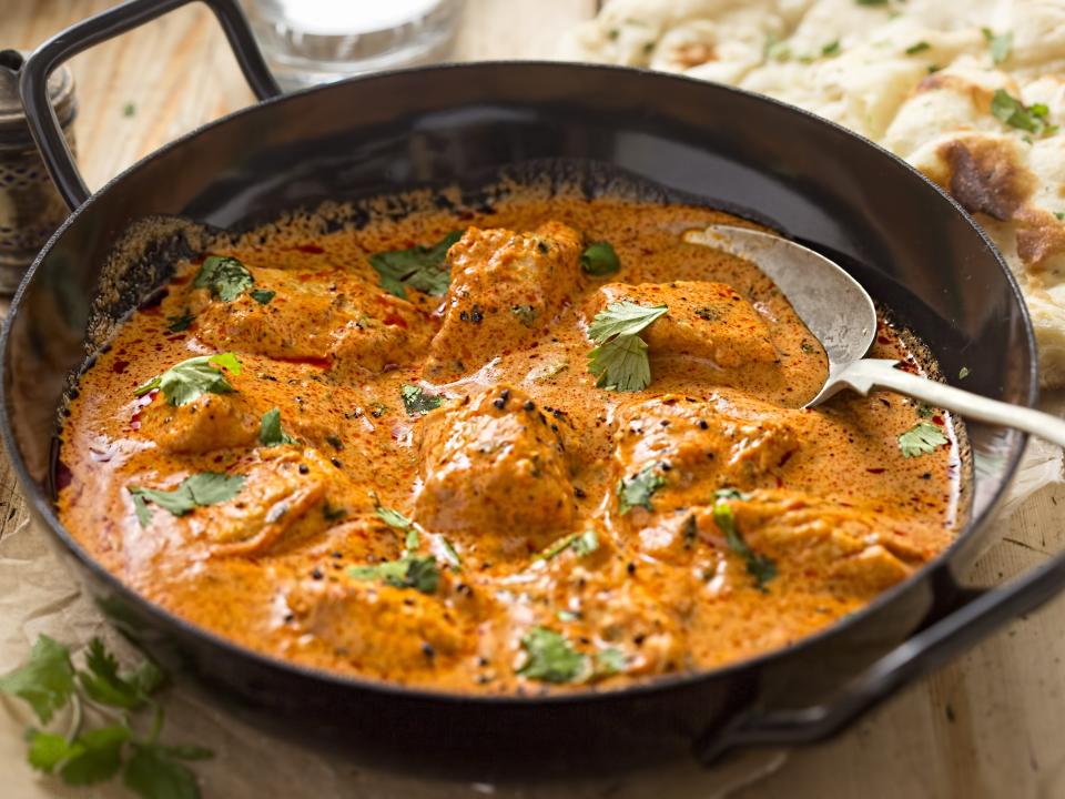 butter chicken in a cast iron pan