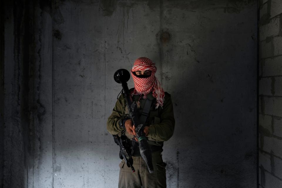 An Israeli soldier dressed as a Palestinian militant, poses for a photo during training session simulating urban warfare at the Zeelim army base, southern Israel Jan. 4, 2022.