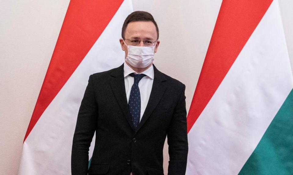 Péter Szijjártó, the Hungarian minister of foreign affairs, with Hungarian flag behind