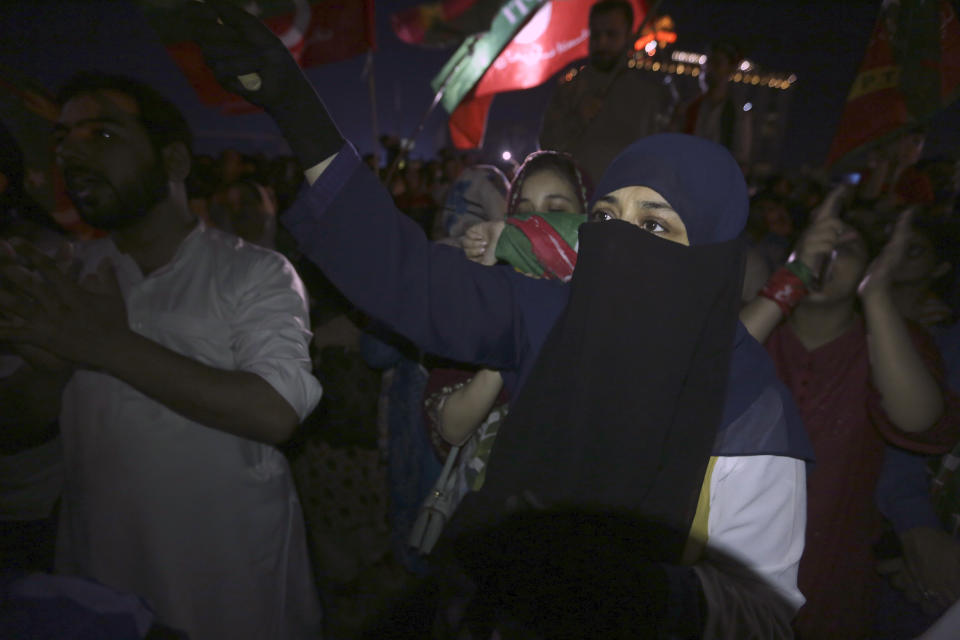 Supporters of former Pakistani Prime Minister Imran Khan's 'Pakistan Tehreek-e-Insaf' party chant slogans as they block a road as protest against against provincial assembly's deputy speaker, Dost Mohammad Mazari for his ruling to invalidate 10 votes in the chief minister elections, in Lahore, Pakistan, Friday, July 22, 2022. Former Pakistani Prime Minister Imran Khan's party was sidelined in a key vote Friday in the local assembly in Punjab province, despite winning there earlier this week. Khan slammed the development and called on his supporters to rally across Pakistan. (AP Photo/K.M. Chaudary)