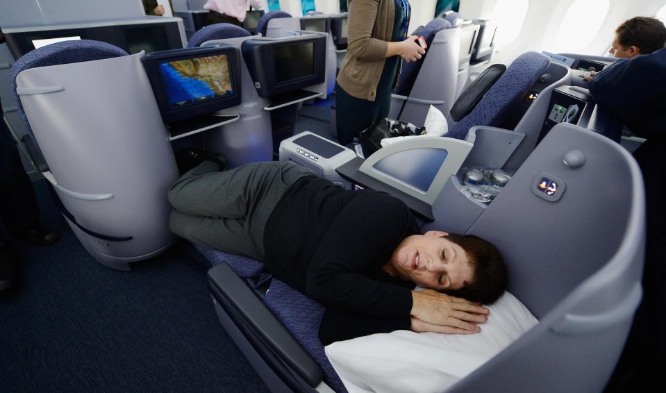 LOS ANGELES, CA - NOVEMBER 30: United Airlines sales manager Marilyn Jablonsky lay down in the reclining seats of Business First class while touring the new Boeing 787 Dreamliner at Los Angeles International Airport on November 30, 2012 in Los Angeles, California. In January the new jet is scheduled to begin flying daily non-stop between Los Angeles International airport and Japan's Narita International Airport and later to Shanghai staring in March. The new Boeing 787 Dreamliner will accomodate 219 travelers with 36 seats in United Business First, 70 seats in Economy Plus and 113 in Economy Class. The carbon-fiber composite material that makes up more than 50 percent of the 787 makes the plane more fuel-efficient. (Photo by Kevork Djansezian/Getty Images)