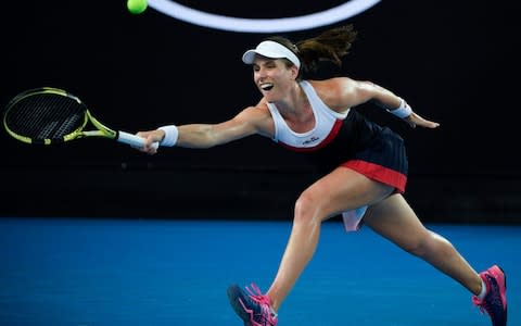 Konta stretches to make a return against Muguruza - Credit: AP