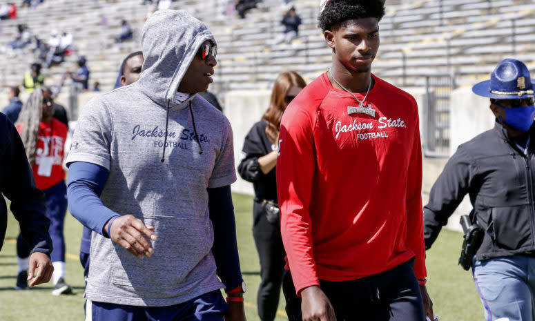 Jackson State coach Deion Sanders walking with quarterback Shedeur Sanders