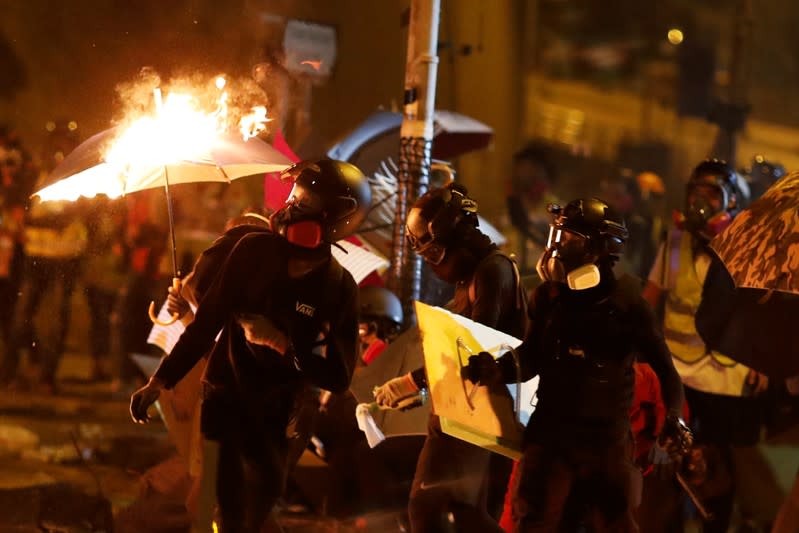 Anti-government protesters are seen during the clashes with a police near the Polytechnic University in Hong Kong