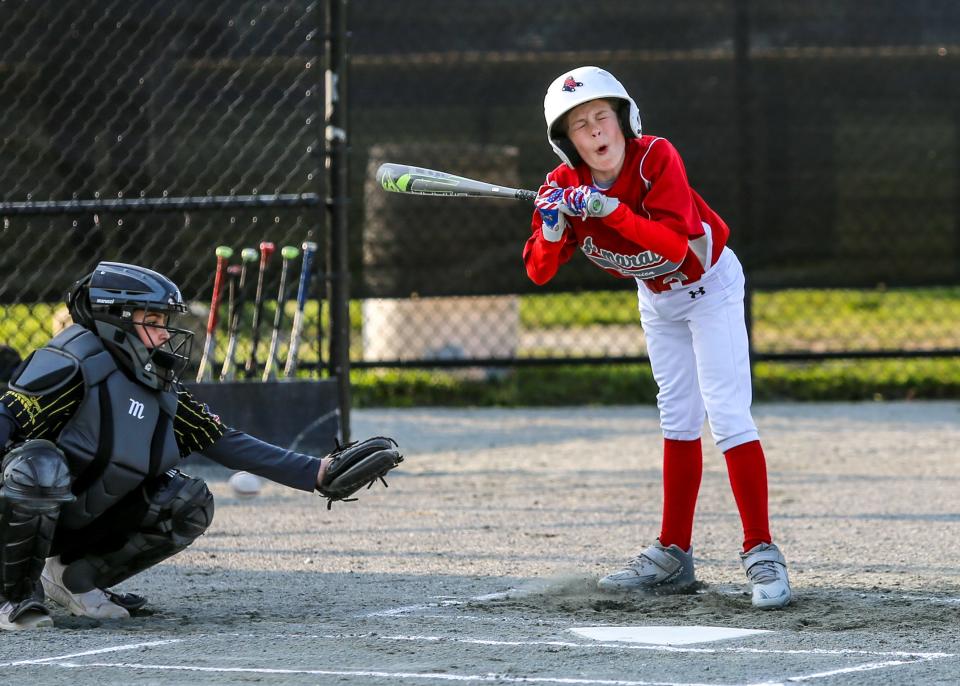 Jack Fleurent of Amaral's Linguica grimaces as he avoids an inside fastball against South Coast Towing in recent action at Whaling City Youth Baseball.