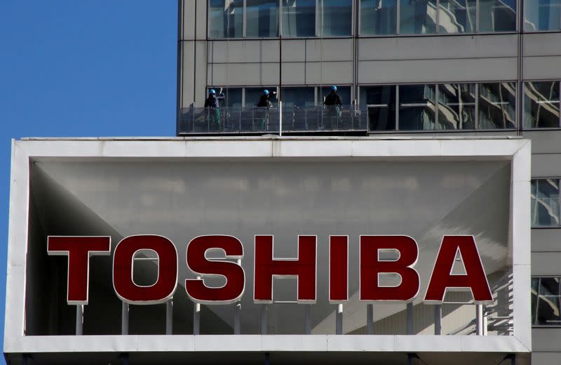 FILE PHOTO: FILE PHOTO: Logo of Toshiba Corp is seen as Window cleaners work on the company's headquarters in Tokyo