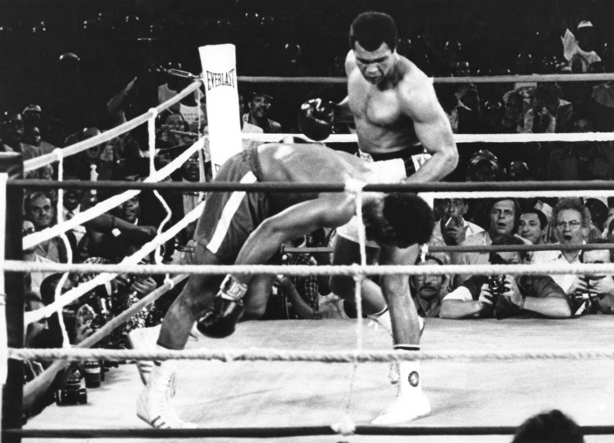 FILE - This is a Oct. 30, 1974 file photo of Muhammad Ali as he watches George Foreman head for the canvas after being knocked out in the eighth round of their match in Kinshasa, Zaire. It was 40 years ago that two men met just before dawn on Oct. 30, 1974, to earn $5 million in the Rumble in the Jungle. In one of boxing&#39;s most memorable moments, Muhammad Ali stopped the fearsome George Foreman to recapture the heavyweight title in the impoverished African nation of Zaire. (AP Photo, File)