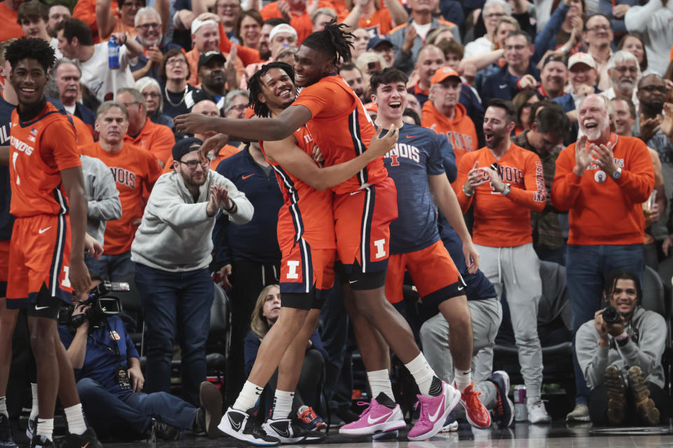 Illinois forwards Ty Rodgers, left, and Dain Dainja (42) celebrate the team's win over UCLA in an NCAA college basketball game Friday, Nov. 18, 2022, in Las Vegas. (AP Photo/Chase Stevens)