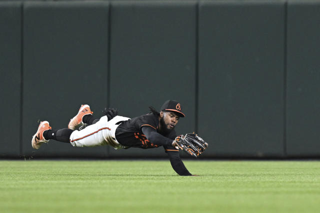 Baltimore Orioles' Cedric Mullins makes a diving catch on a ball hit by Pittsburgh Pirates Jack Suwinski in the seventh inning of a baseball game, Friday, May 12, 2023, in Baltimore. (AP Photo/Gail Burton)