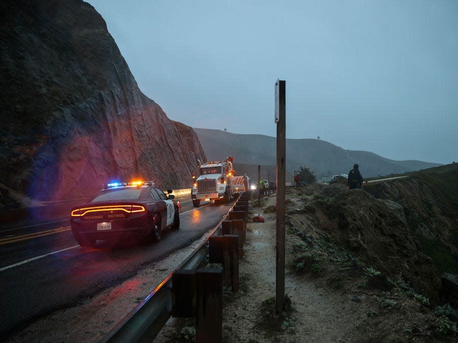 Rescue teams are seen at the scene as a Tesla with four occupants plunged over a cliff on Pacific Coast Highway 1 at Devils Slide on January 2, 2022 in San Mateo County, California, United States.