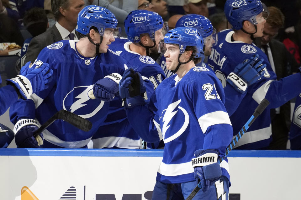 Tampa Bay Lightning center Brayden Point (21) celebrates with the bench after his goal against the Carolina Hurricanes during the first period of an NHL hockey game Tuesday, Oct. 24, 2023, in Tampa, Fla. (AP Photo/Chris O'Meara)