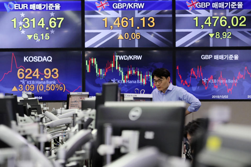 A currency trader watches monitors at the foreign exchange dealing room of the KEB Hana Bank headquarters in Seoul, South Korea, Monday, Oct. 7, 2019. Asian shares were mixed Monday, following a healthy report on U.S. jobs, while investors cautiously awaited the upcoming trade talks between the U.S. and China. (AP Photo/Ahn Young-joon)
