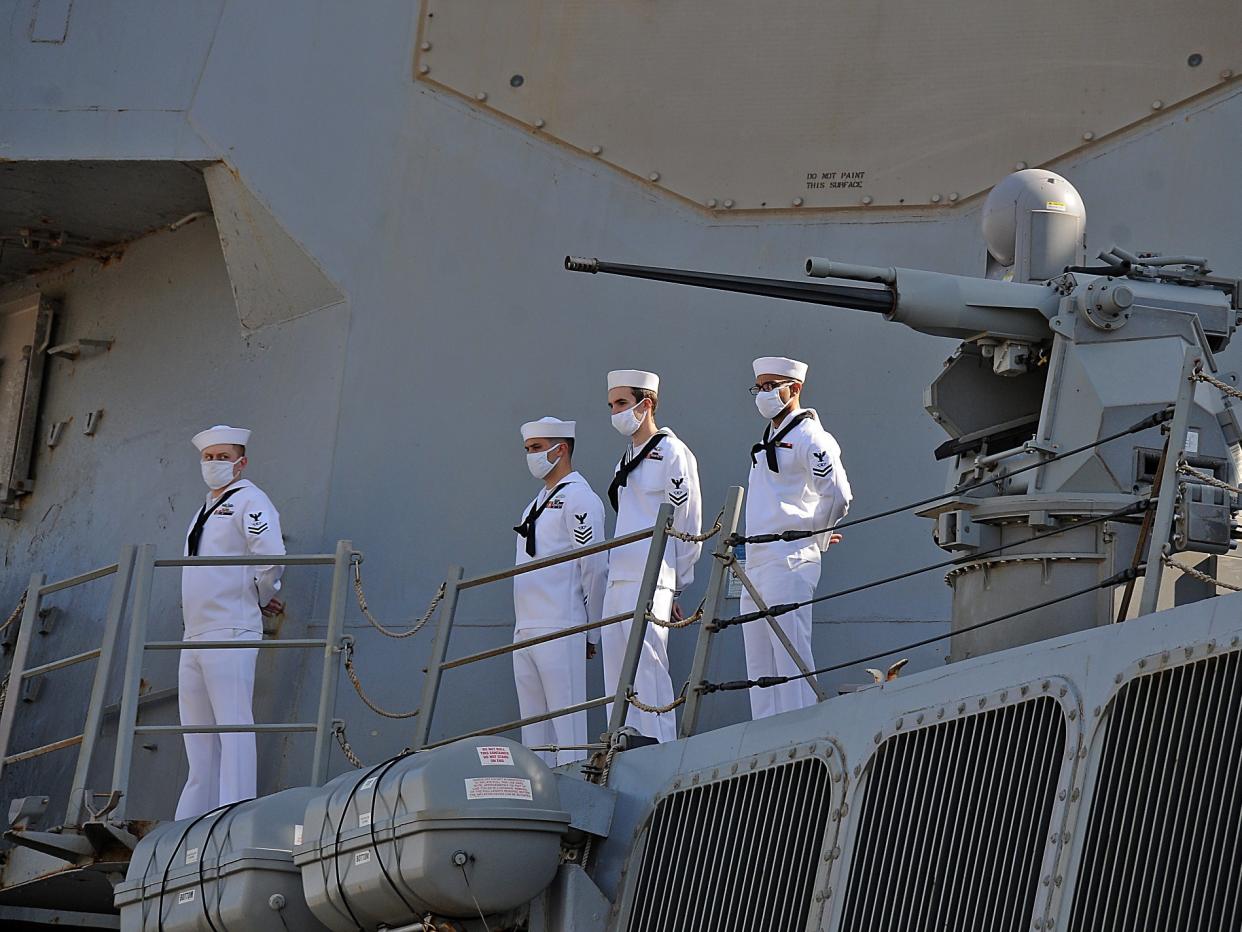 US sailors look on as they stand aboard the US Navy guided-missile destroyer USS Winston S. Churchill (DDG 81), part of Destroyer Squadron 2, while it anchors in Port Sudan on March 1, 2021.  (AFP via Getty Images)