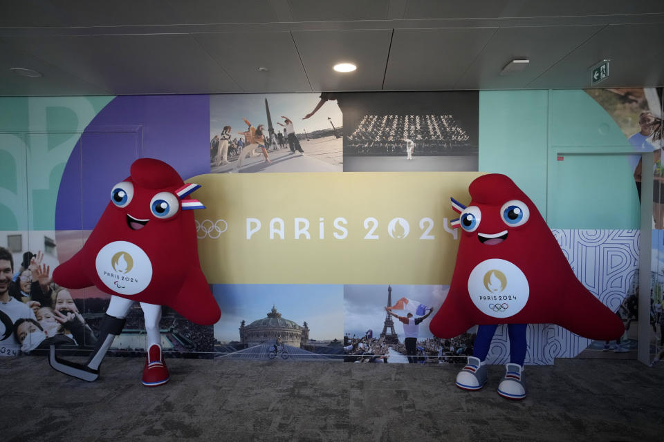 Mascots of the 2024 Paris Olympic Games, right, and Paralympics Games, a Phrygian cap, pose during a preview in Saint Denis, outside Paris, Thursday, Nov. 10, 2022. The soft bright red cap, also known as a liberty cap, is an updated version of a conical hat worn in antiquity in places such as Persia, the Balkans, Thrace, Dacia and Phrygia, where the name originates, in modern day Turkey. It later became a symbol of the pursuit of liberty in the French Revolution and is still worn by the figure of Marianne, the national personification of France since that time. (AP Photo/Christophe Ena)