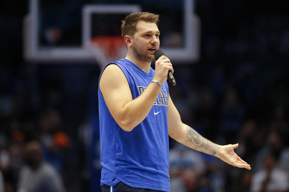 Dallas Mavericks guard Luka Doncic (77) welcomes fans back to a full capacity arena before the first half of an NBA basketball game against the Houston Rockets, Tuesday, Oct. 26, 2021, in Dallas. (AP Photo/Brandon Wade)