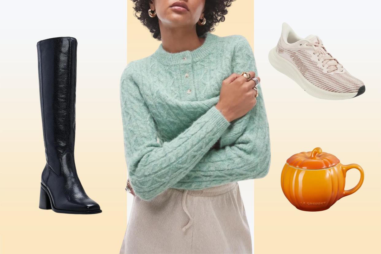 A model wearing a green cardigan, black boots, pink hoka sneakers and a pumpkin mug on a yellow background.