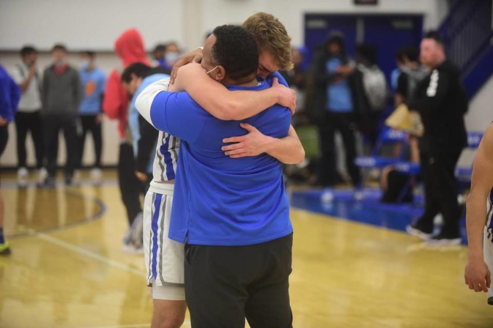 Atwater High junior Tyler Parr hugs Falcons assistant coach Seneca Ybarra after an emotional 58-53 win over El Capitan on Friday, Feb. 4, 2022. Parr has been playing with a heavy heart after his father Steven Parr recently died. Shawn Jansen/Sjansen@mercedsun-star.com