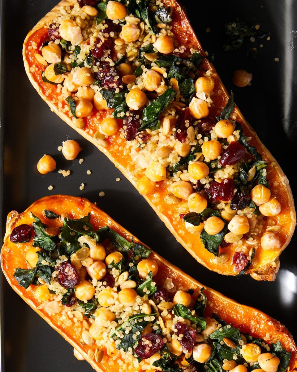 <p>After baking brown-sugar-butter-slathered squash until perfectly tender, you'll top the squash with a hearty filling of quinoa, kale, and chickpeas. Flecked with dried cranberries and pumpkin seeds, the savory pilaf has the perfect balance of texture, flavor, and pops of color.<br><br>Get the <strong><a href="https://www.delish.com/cooking/recipe-ideas/a40510457/stuffed-butternut-squash-recipe/" rel="nofollow noopener" target="_blank" data-ylk="slk:Stuffed Butternut Squash recipe;elm:context_link;itc:0;sec:content-canvas" class="link ">Stuffed Butternut Squash recipe</a></strong>.</p>