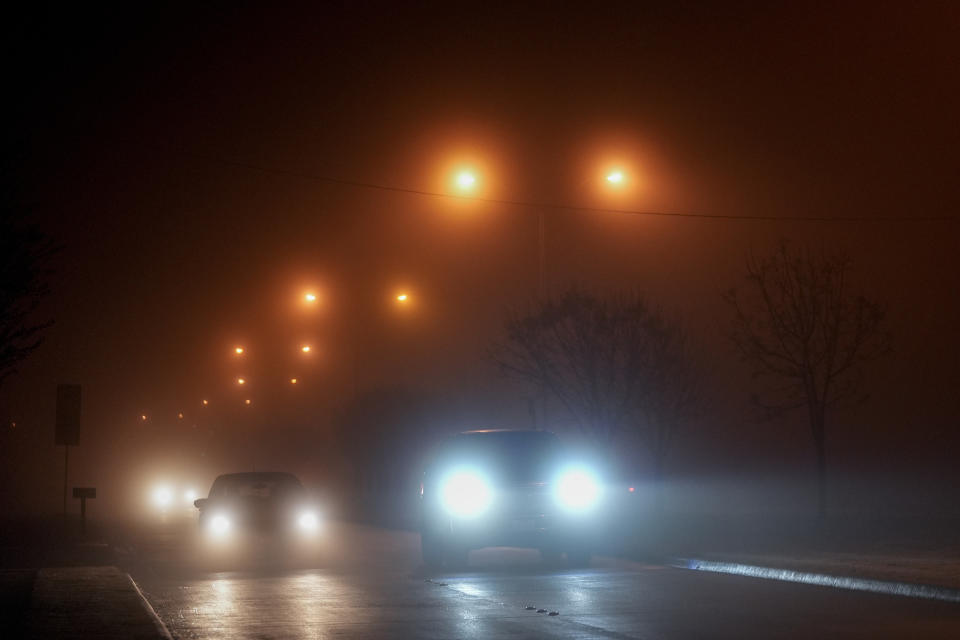 Fog blankets vehicles during the evening commute, Tuesday, Jan. 23, 2024, in Mansfield, Texas. (AP Photo/Julio Cortez)