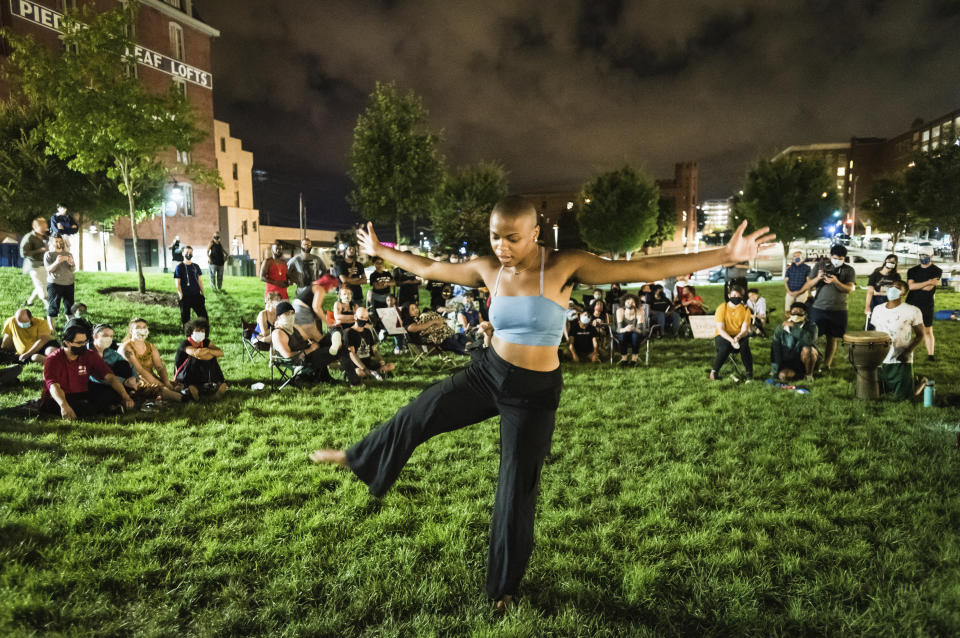 Nia Sadler performs a dance routine during a vigil for John Neville on Wednesday, Aug. 5, 2020, in Bailey Park in Winston-Salem, N.C. Demonstrators held the vigil to call for justice in the case of Neville, a Black man who died days after his arrest. The vigil came hours after jail videos were released that showed Neville struggling with guards and yelling he couldn’t breathe as they restrained him in December. (Allison Lee Isley/The Winston-Salem Journal via AP)