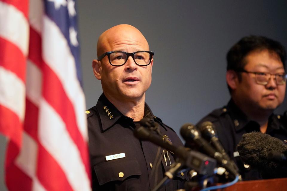 Dallas police Chief Eddie Garcia, left, speaks to reporters about a recent shooting as senior corporal Soo Kim stands by during a news conference at police headquarters headquarters in Dallas, Tuesday, May 17, 2022. The girlfriend of a man arrested in Dallas in a shooting that wounded three women in a Koreatown hair salon told police he had been admitted to health facilities because he was having delusions about Asian Americans, according to an arrest warrant affidavit. (AP Photo/LM Otero)