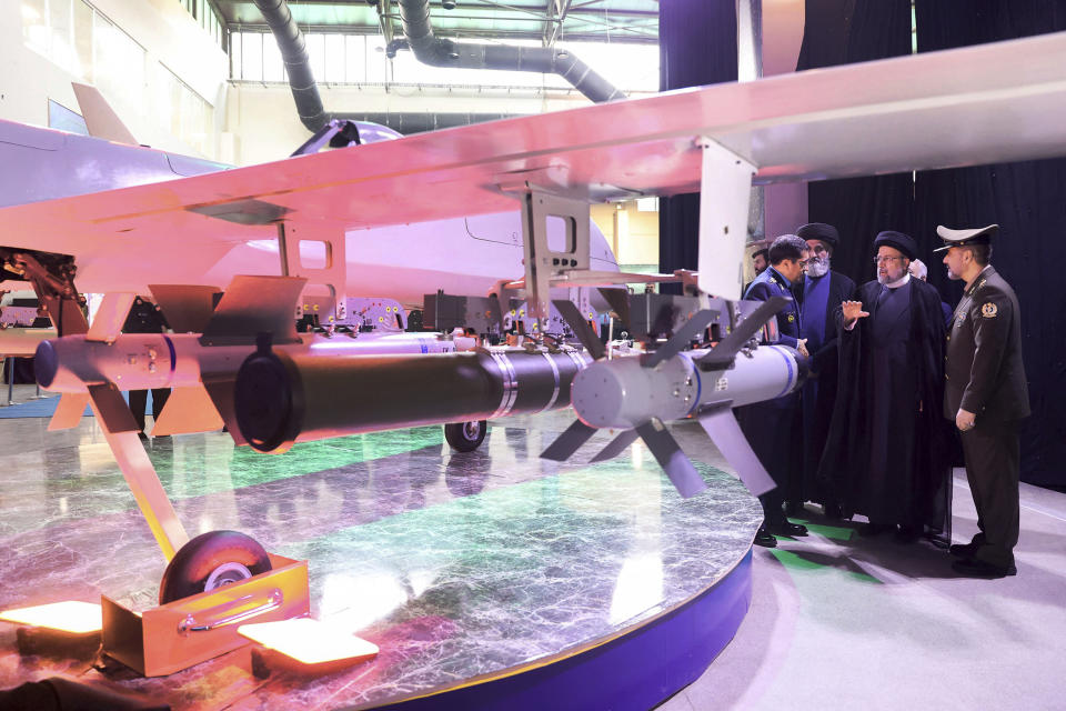 In this photo released by the Iranian Presidency Office, President Ebrahim Raisi, second right, speaks with Chief of Aviation Industries of Armed Forces Gen. Afshin Khajehfard, left, as Defense Minister Gen. Mohammad Reza Gharaei Ashtiani, right, listens, during a ceremony unveiling a drone called the Mohajer-10, Tuesday, Aug. 22, 2023. Iran's Defense Ministry unveiled a drone Tuesday resembling America's armed MQ-9 Reaper, claiming that the aircraft capable of staying airborne for 24 hours and having the range to reach its archenemy Israel. (Iranian Presidency Office, via AP)