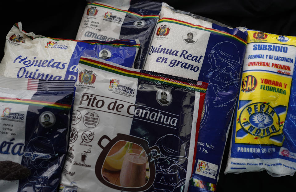 In this Jan. 21, 2020 photo, packages of government subsidized food emblazoned with an image of Bolivia's former President Evo Morales, are displayed in La Paz, Bolivia. With the same fire that his successor now tries to erase his name, Morales did everything to put his image and name into the most unexpected corners of Bolivian homes. Like these food packages that still bear his image. (AP Photo/Juan Karita)