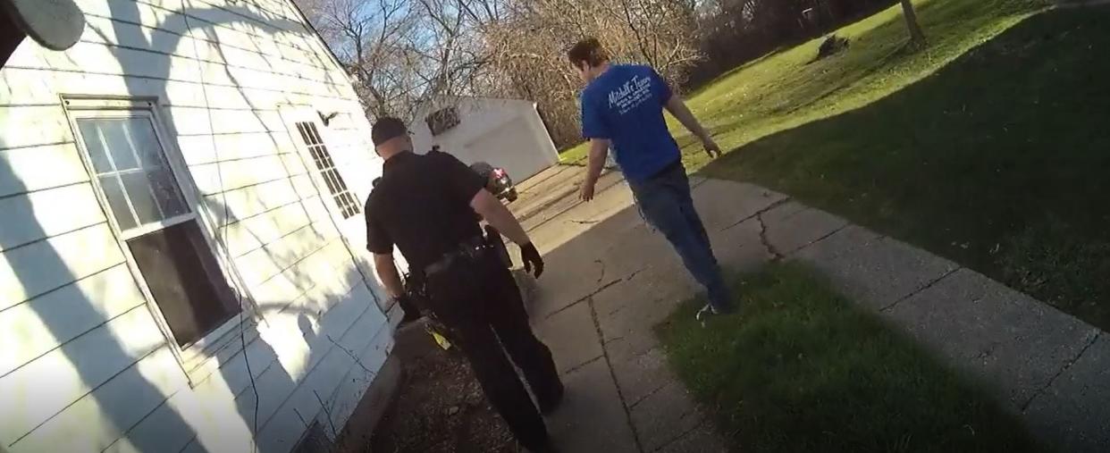 A man seen in police body camera footage leads a Milwaukee police officer into the home of Michael Mattioli while he was in a physical altercation with Joel Acevedo on April 19, 2020. Acevedo, 25, died days later. Body camera footage released by the Milwaukee Police Department was heavily redacted, in accordance with a court order.