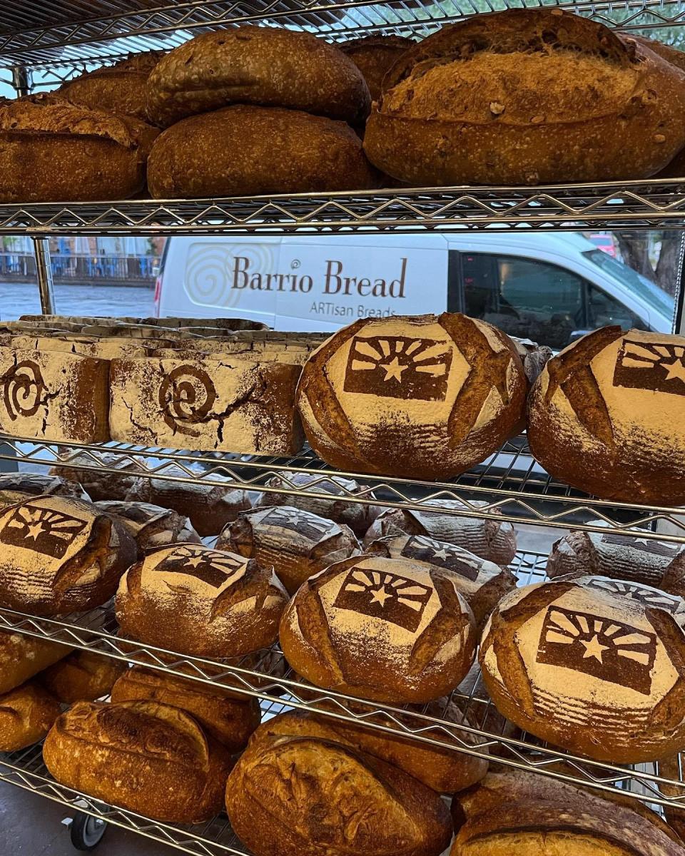 Barrio Bread loaves with the Arizona Flag sit on a shelf.