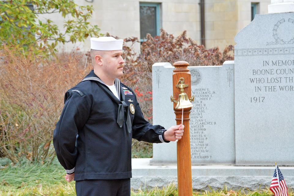 Petty Officer 1st Class Kenneth Fields rings a bell Wednesday for the ships and lives lost recognizing the 81st anniverary of the attack on Pearl Harbor during a ceremony at the Boone County war memorials at the Boone County Courthouse. 