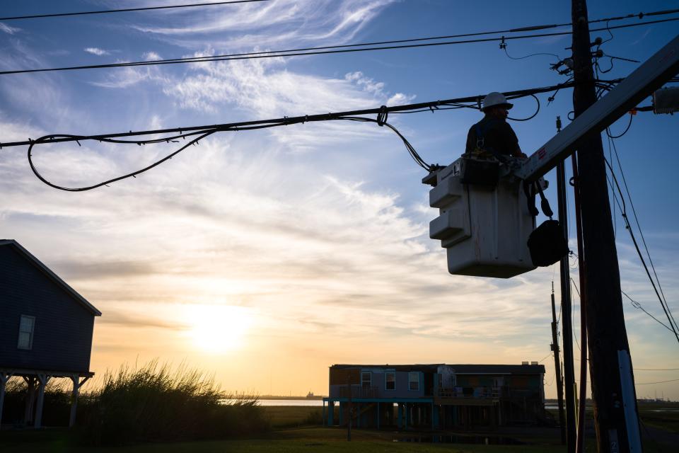 A utility worker works to restore a damaged power-line after Hurricane Beryl swept through the area on July 8, 2024 in Surfside, Texas. Tropical Storm Beryl developed into a Category 1 hurricane as it hit the Texas coast.