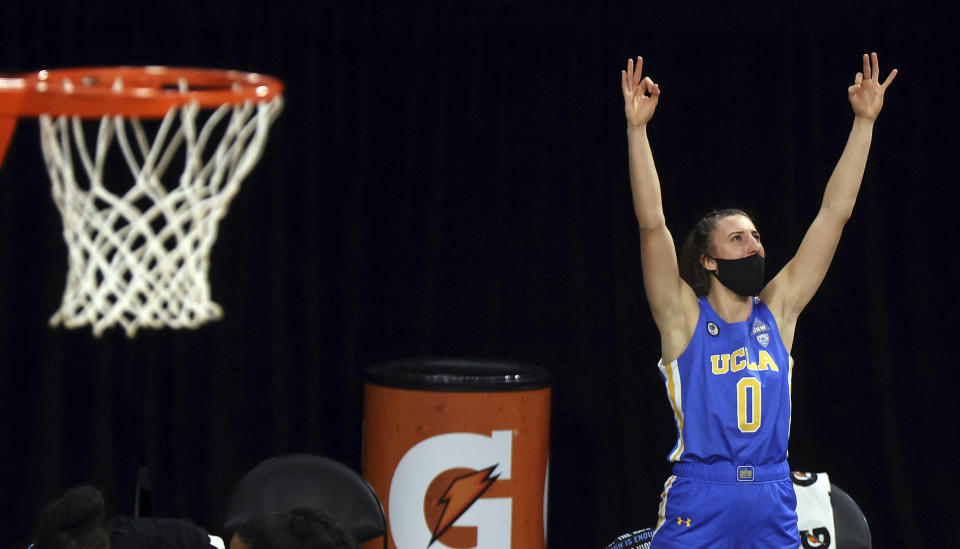 UCLA guard Chantel Horvat (0) celebrates a teammate's 3-point against Arizona during the second half of an NCAA college basketball game in the semifinals of the Pac-12 women's tournament Friday, March 5, 2021, in Las Vegas. (AP Photo/Isaac Brekken)