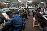 Employees work at a diamond jewellery manufacturing factory in Mumbai