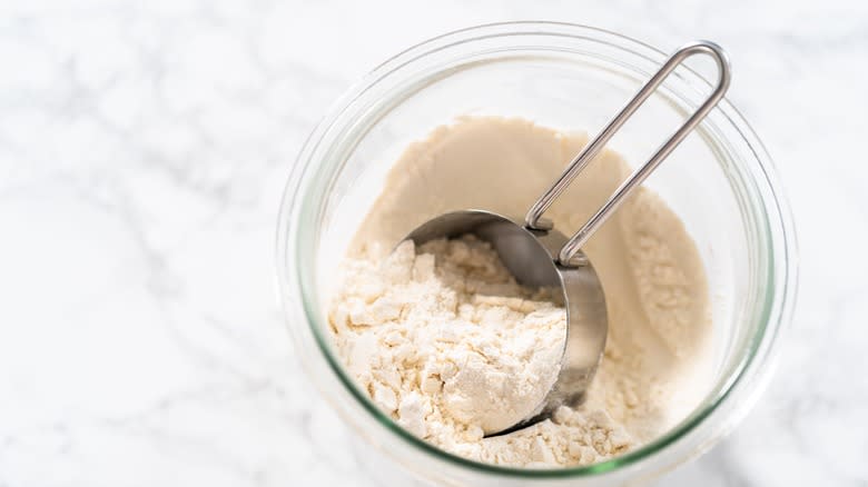 Measuring cup in flour