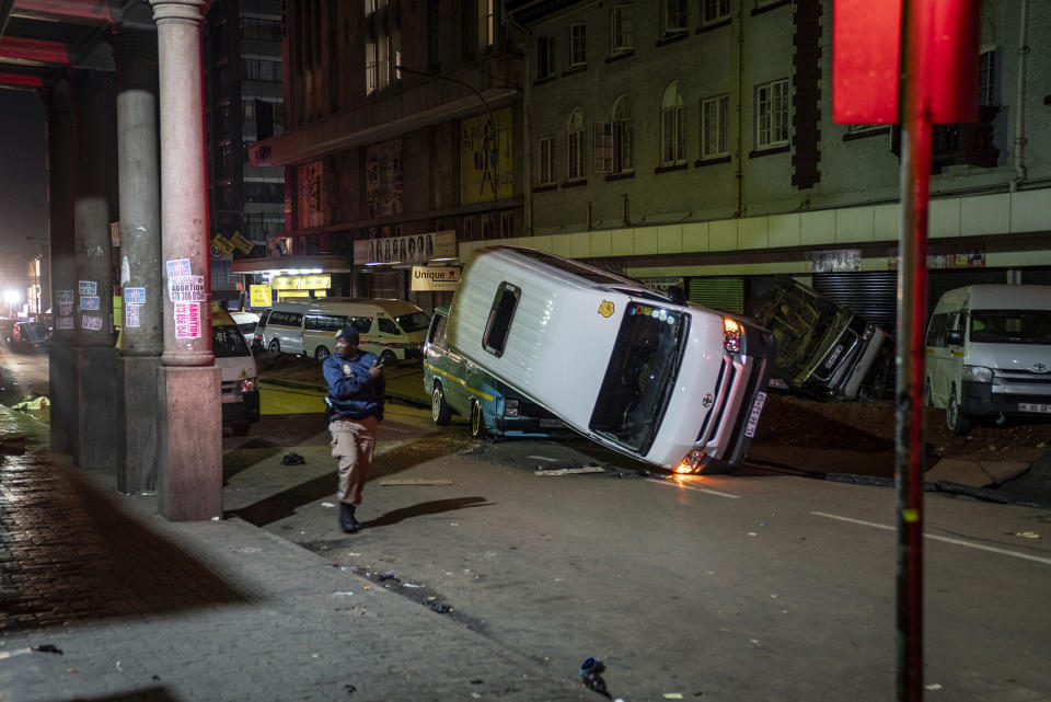 Emergency services gather at the scene of a gas explosion downtown Johannesburg, South Africa, Wednesday July 19, 2023. Search and rescue officials also ordered residents in nearby buildings to evacuate the area and the area where the explosion happened was cordoned off. (AP Photo/Shiraaz Mohamed)