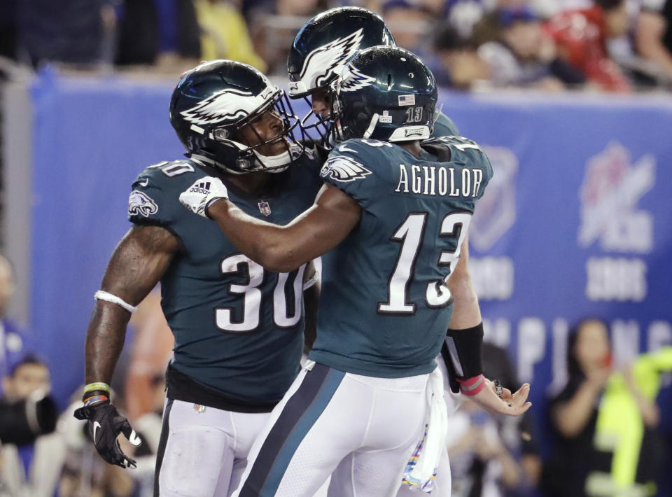 Philadelphia Eagles running back Corey Clement (30) celebrates with teammates Nelson Agholor (13) and Carson Wentz after rushing for a touchdown during the first half of an NFL football game against the New York Giants on Thursday, Oct. 11, 2018, in East Rutherford, N.J. (AP Photo/Julio Cortez)