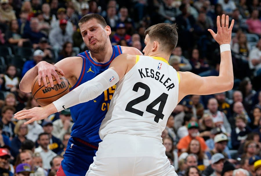 Denver Nuggets center Nikola Jokic, left, drives against Utah Jazz center Walker Kessler during the first half of an NBA basketball game Saturday, March 9, 2024, in Denver.