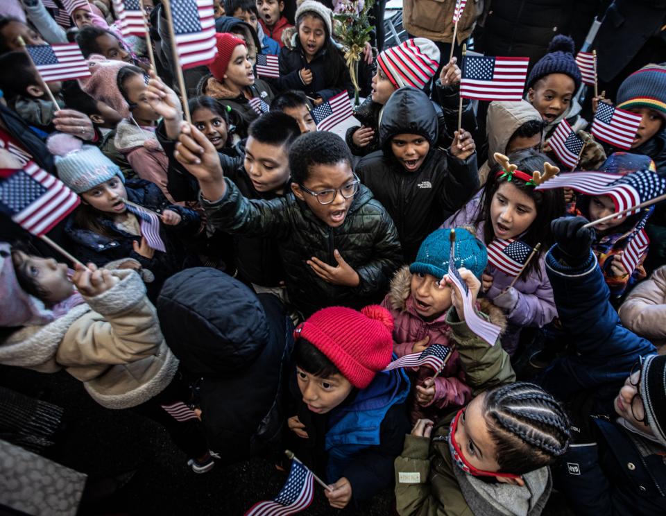 Elmsford school children recite the pledge of allegiance at a ceremony recognizing Wreaths Across America, the organization that is making its way from Maine to Arlington National Cemetery in Virginia to lay wreaths at graves of military veterans buried at the national cemetery. A convoy of tractor trailers, carrying 70,000 wreaths, stopped in Elmsford for a ceremony in which local elected officials, school children, and area residents greeted the dozens of members of Wreaths Across America making the trip to Virginia. The convoy is making stops all along their route, with the stop in Elmsford being the only one in New York State.